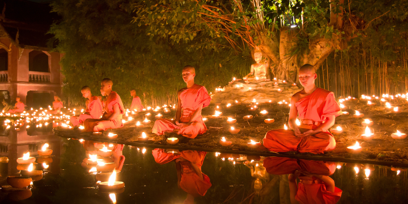 budhhist monks meditating outside
