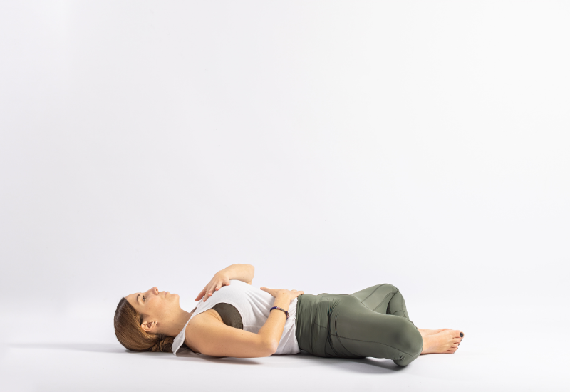 a girl doing reclined butterfly pose
