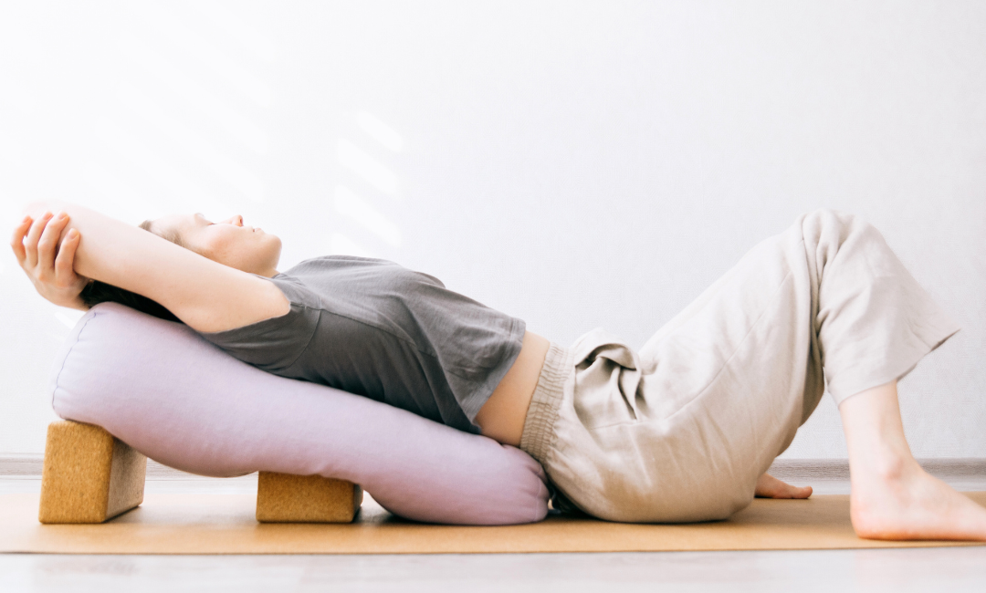 a girl resting in a reclining yin yoga pose