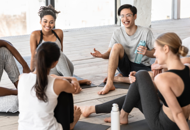 a group of people chatting after their yoga class<br />
