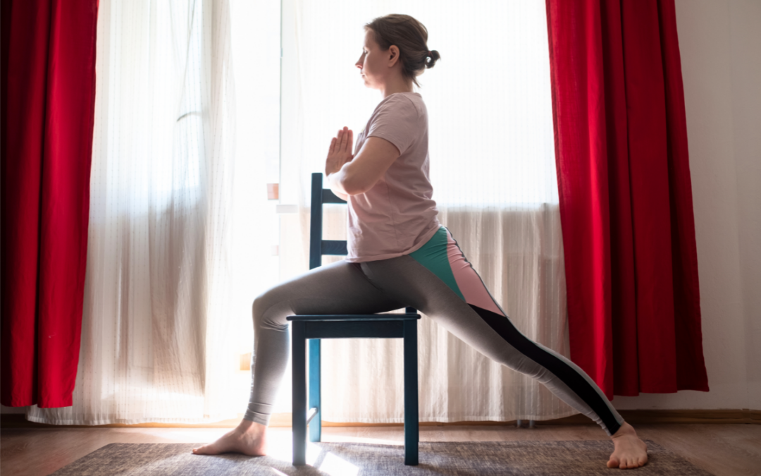 a girl doing warrior 1 on the chair