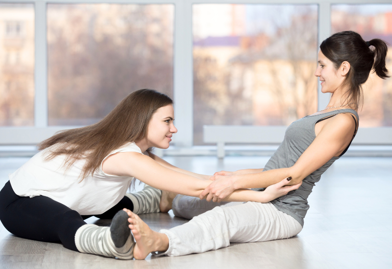 seated straddle partner yoga pose