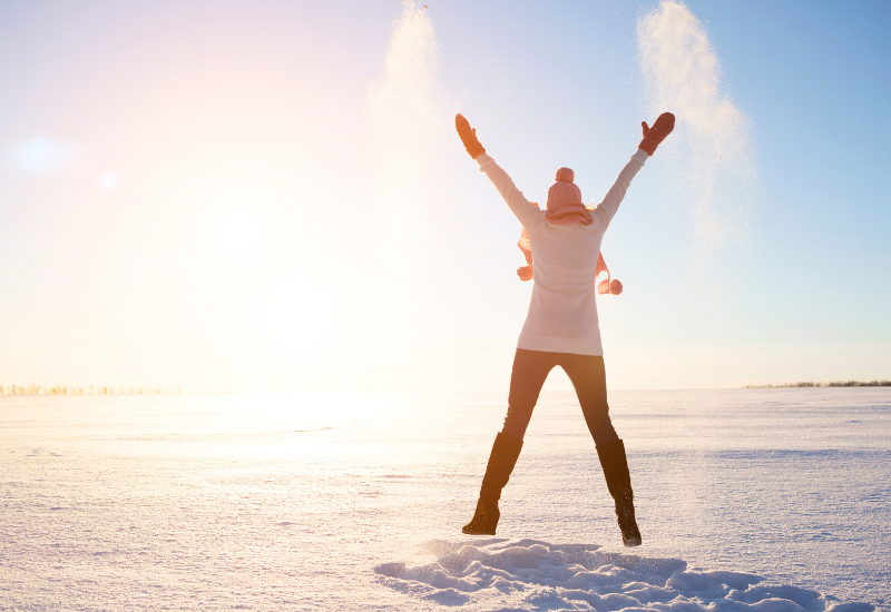 a girl soaking in sun in snow