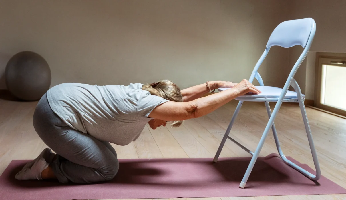 old woman doing chair yoga