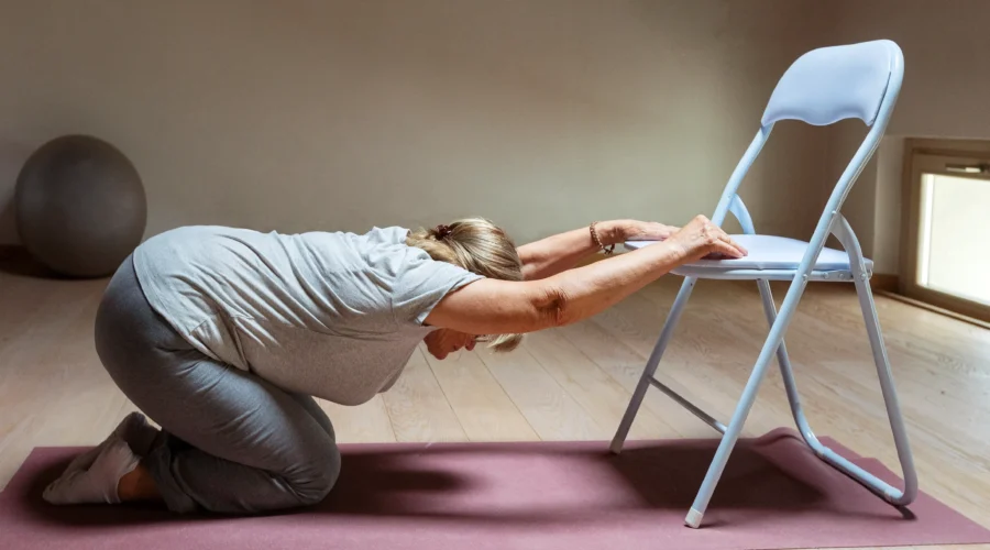 old woman doing chair yoga