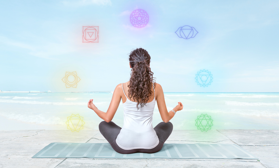 a woman meditating on the beach