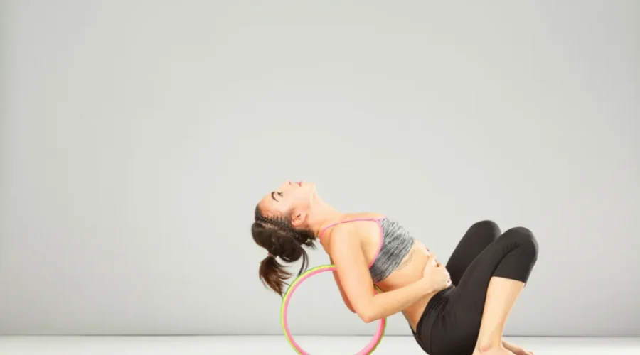 a girl doing seated backbend