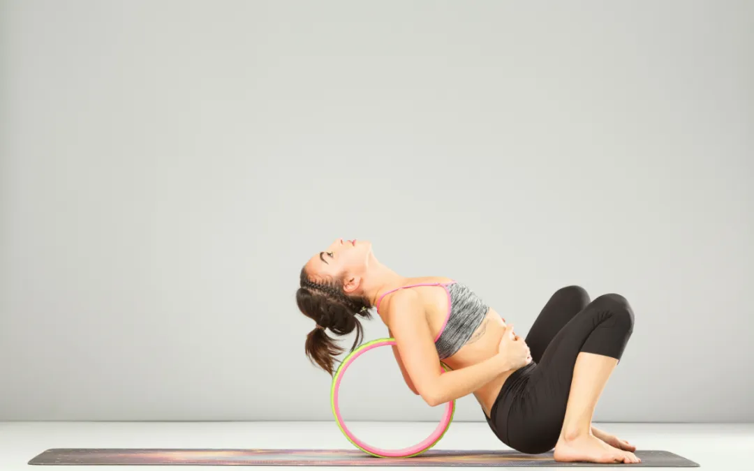 a girl doing seated backbend