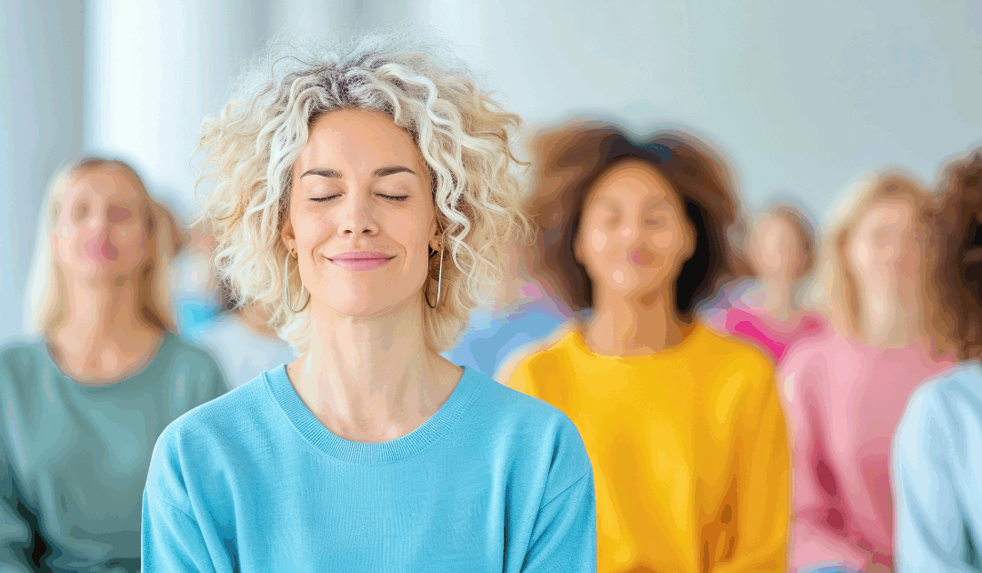 people meditating and smiling in a group yoga class
