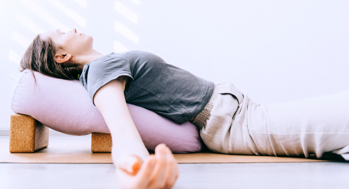 Untitled design (1) a girl doing restorative yoga