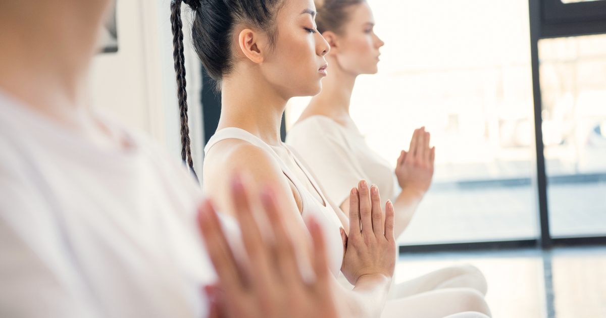 girls meditating with hands folded in namaste