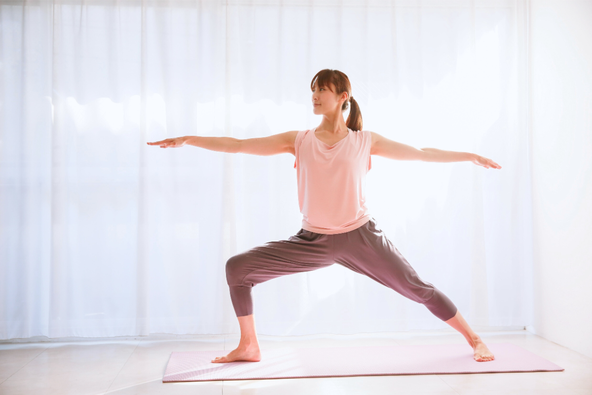 a girl doing warrior pose for better posture