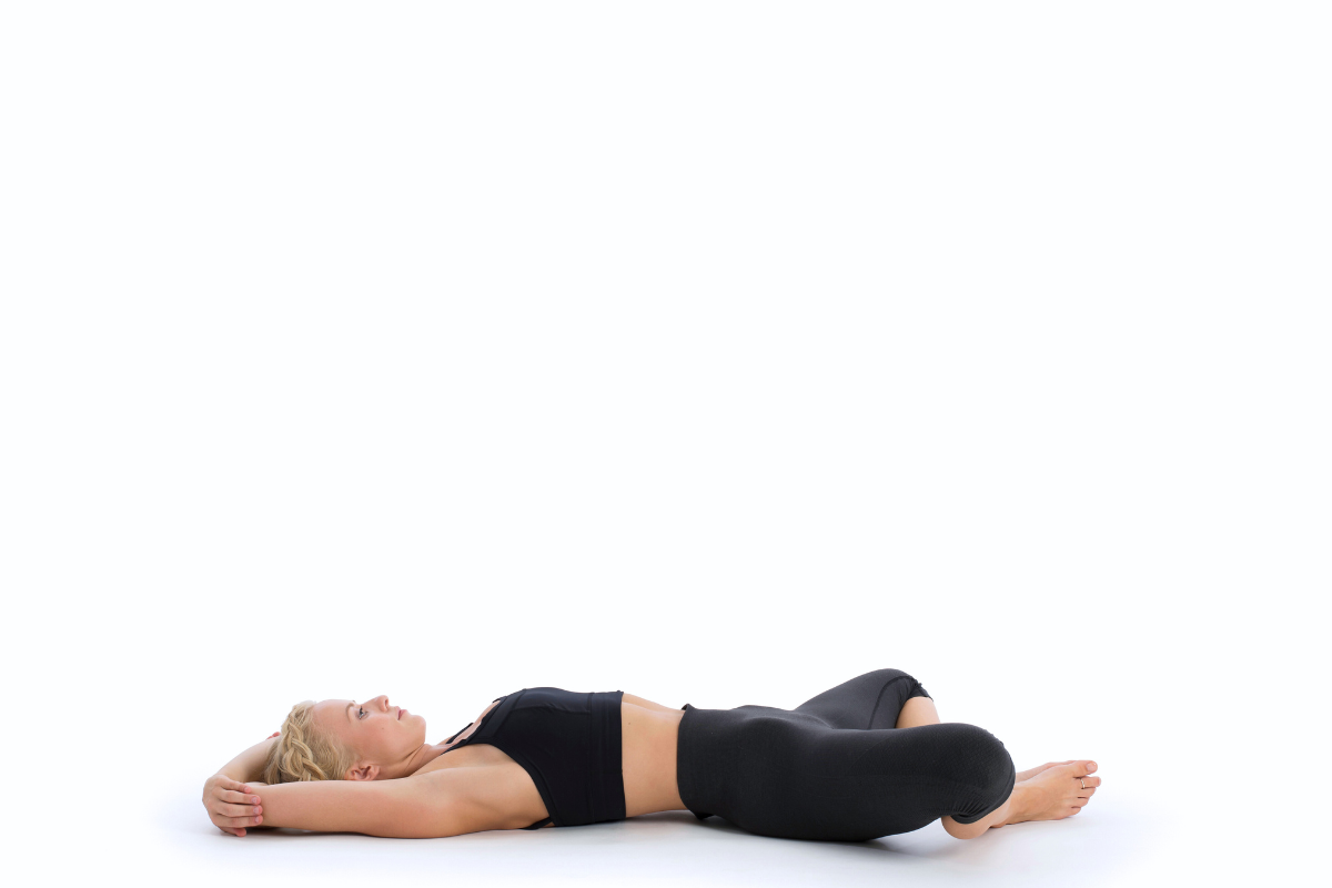 a girl doing reclined bound angled pose to relieve herself of flu, cold and influenza