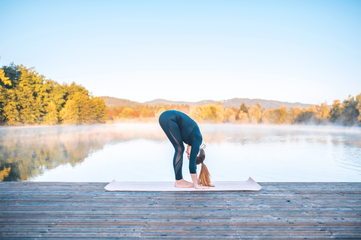 a girl doing standing forward fold