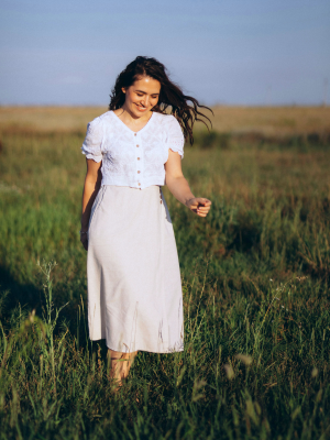 Woman walking in a grassy field