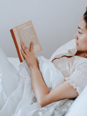 Woman reading a book in bed