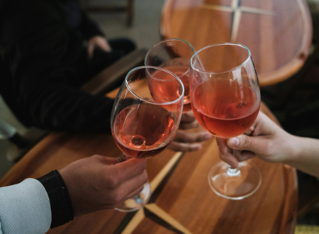 people clanking glasses filled with alcoholic drinks