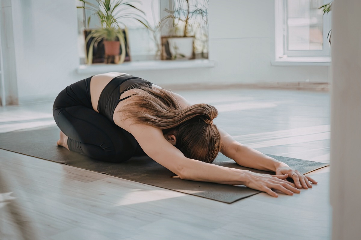 a girl doing child's pose