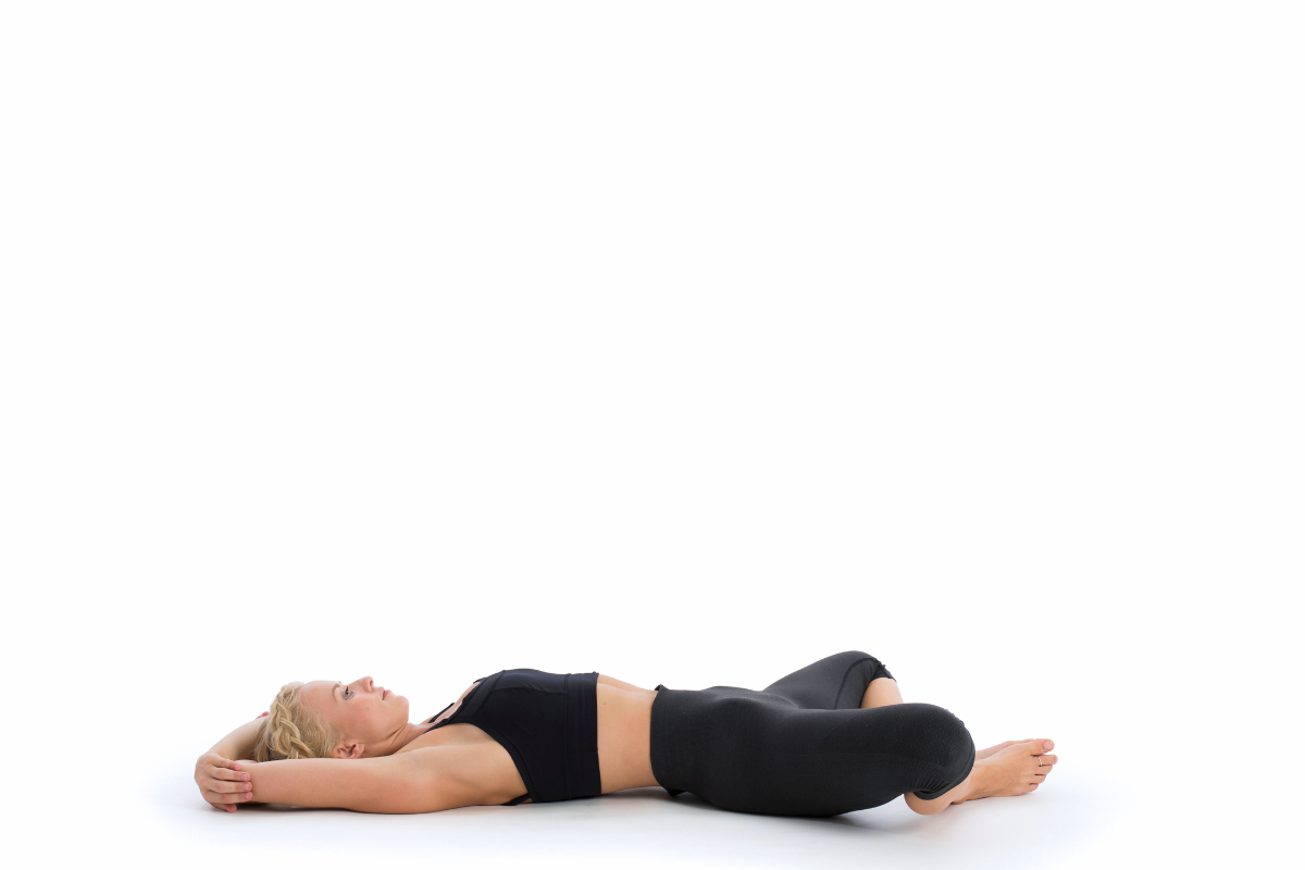 a girl doing reclined bound angled pose