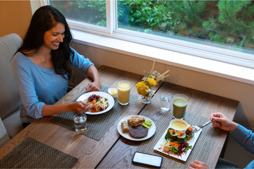 a couple eating vegan food at  a restaurant